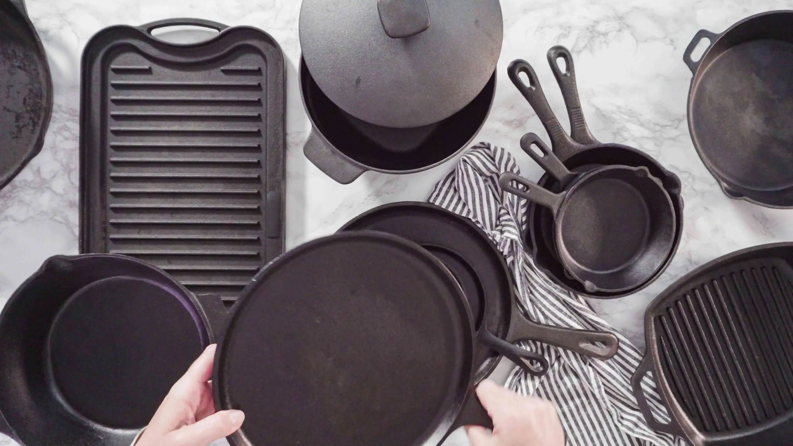 Different types of cast iron cookware including skillets, Dutch ovens, and griddles for various cooking methods